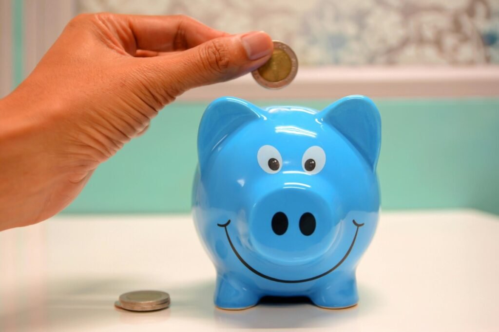 Piggy bank with coin representing financial savings — illustrating How Much Money You Save by Not Having Children (With Data).