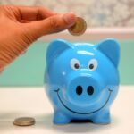 Piggy bank with coins representing financial savings — illustrating How Much Money You Save by Not Having Children (With Data).