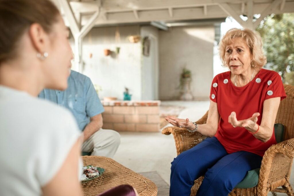 A calm conversation between an adult daughter and her elderly mother at home, symbolizing the guidance in How to Tell Your Family You’re Childfree: A Step-by-Step Guide.