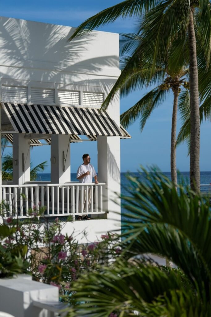 Luxury overwater villa retreat in the Maldives with a private deck, daybed, and ladder into turquoise sea, representing the ultimate strategic travel planning goal for childfree couples and solo travelers.