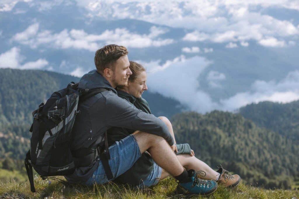 Couple embracing on a mountain overlooking the horizon, representing living a childfree life.