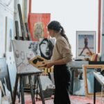 Woman painting on canvas, symbolizing meaning of life without children through creative expression and personal purpose.