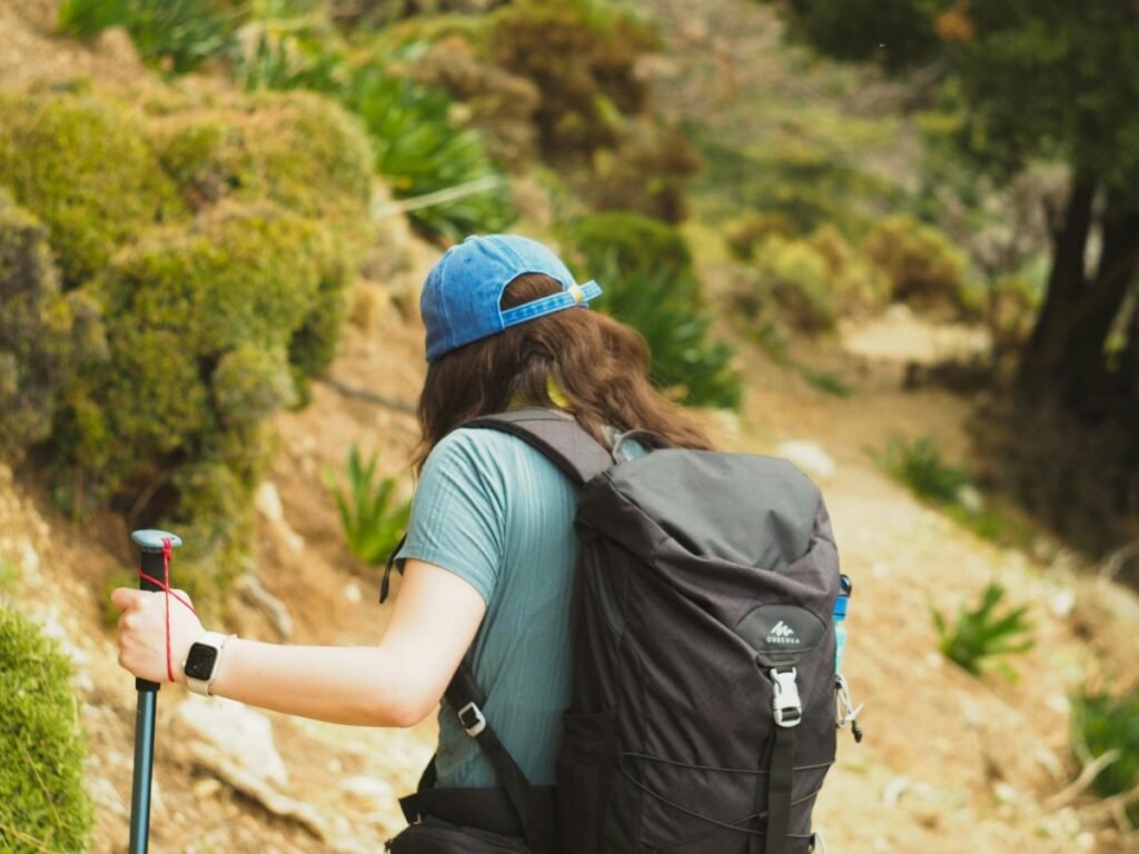 A professional solo traveler exploring a scenic coastal trail in Fethiye, representing secure and confident solo SINK travel.