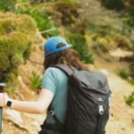 A professional solo traveler exploring a scenic coastal trail in Fethiye, representing secure and confident solo SINK travel.