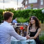 couple having a thoughtful conversation on a date about wanting kids.